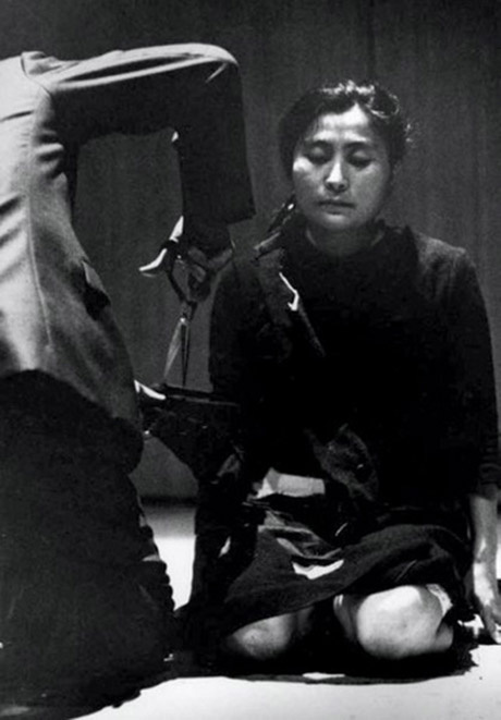 Yoko Ono performing "Cut Piece" on July 20, 1964 at Yamaichi Concert Hall, Kyoto, Japan. Photographe Yoko Ono performing "Cut Piece" on July 20, 1964 at Yamaichi Concert Hall, Kyoto, Japan. Photographe