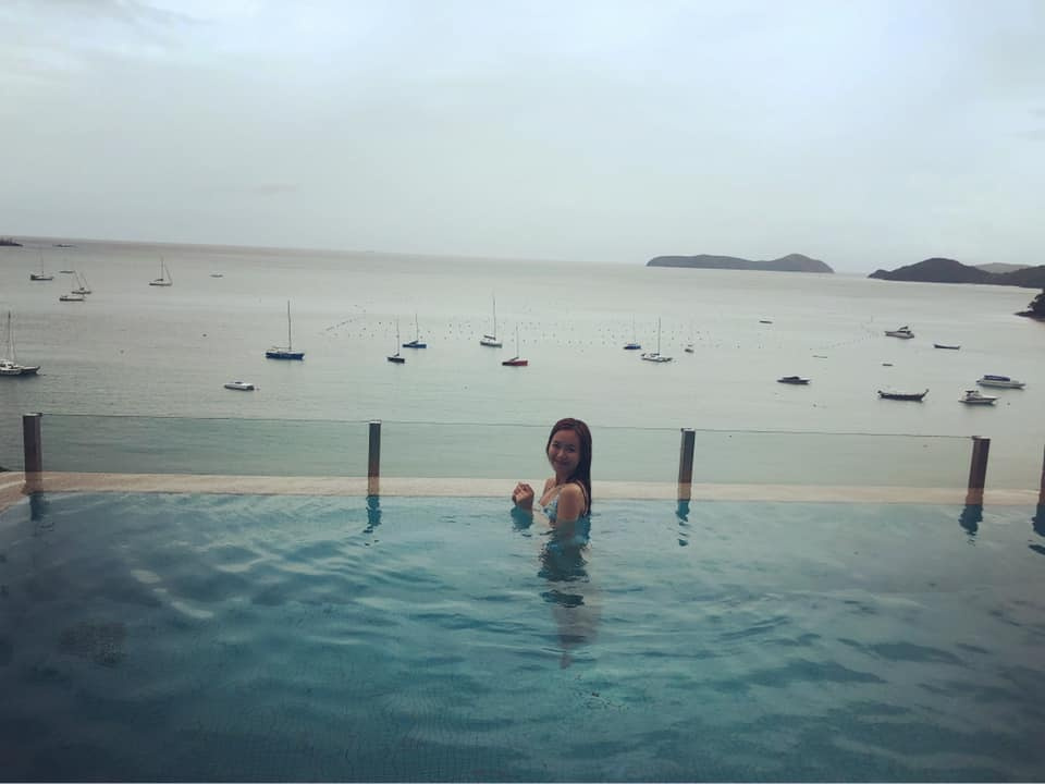 Lil Wuyn. Woman bathing in blue ocean