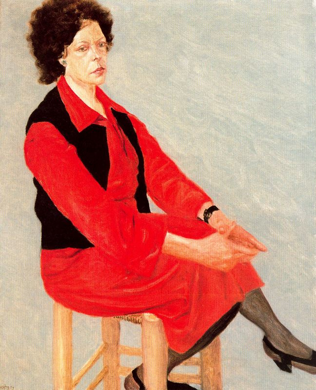 Avigdor Arica. A woman in a red suit and a black vest