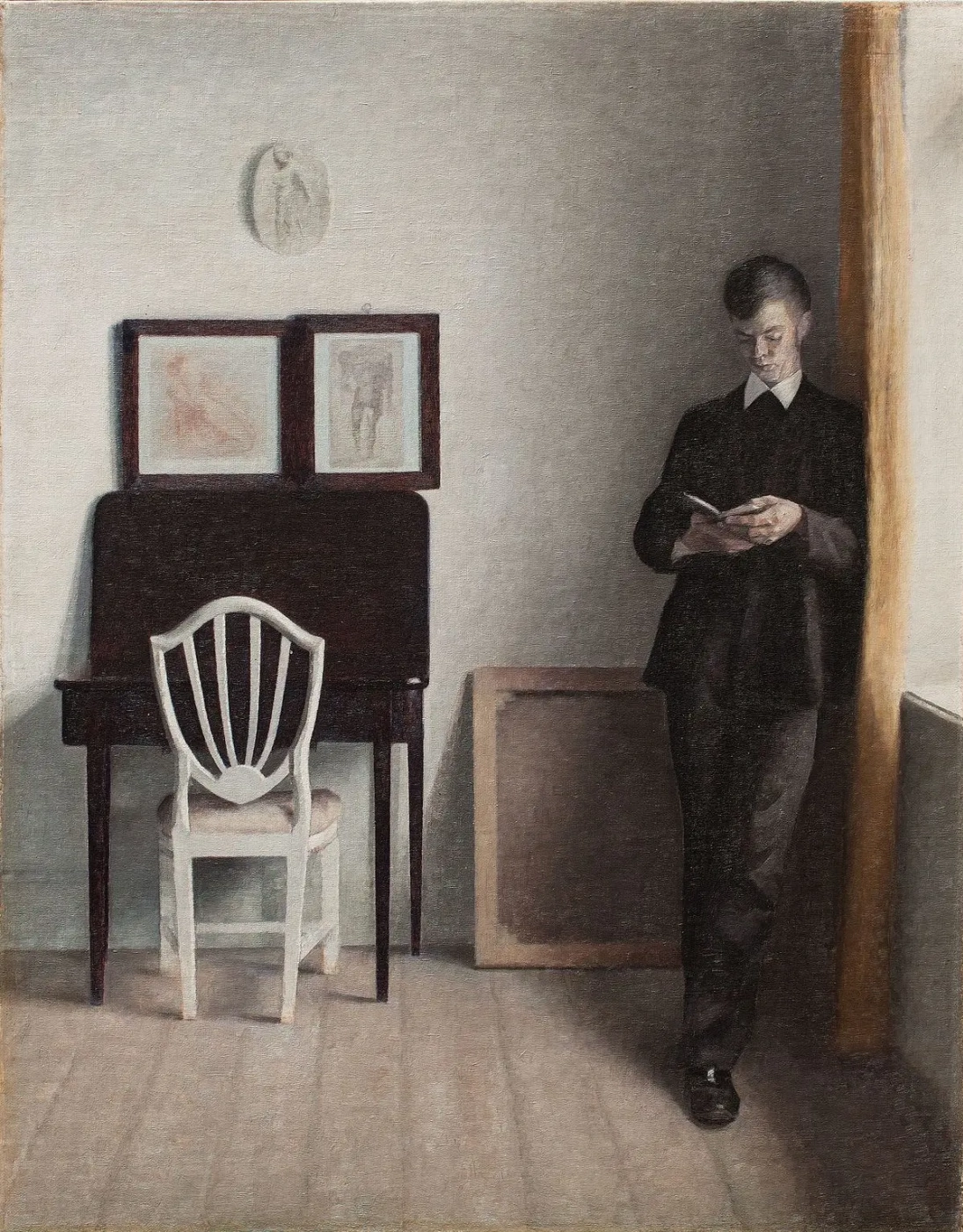 Vilhelm Hammershøi. Interior with a reading young man