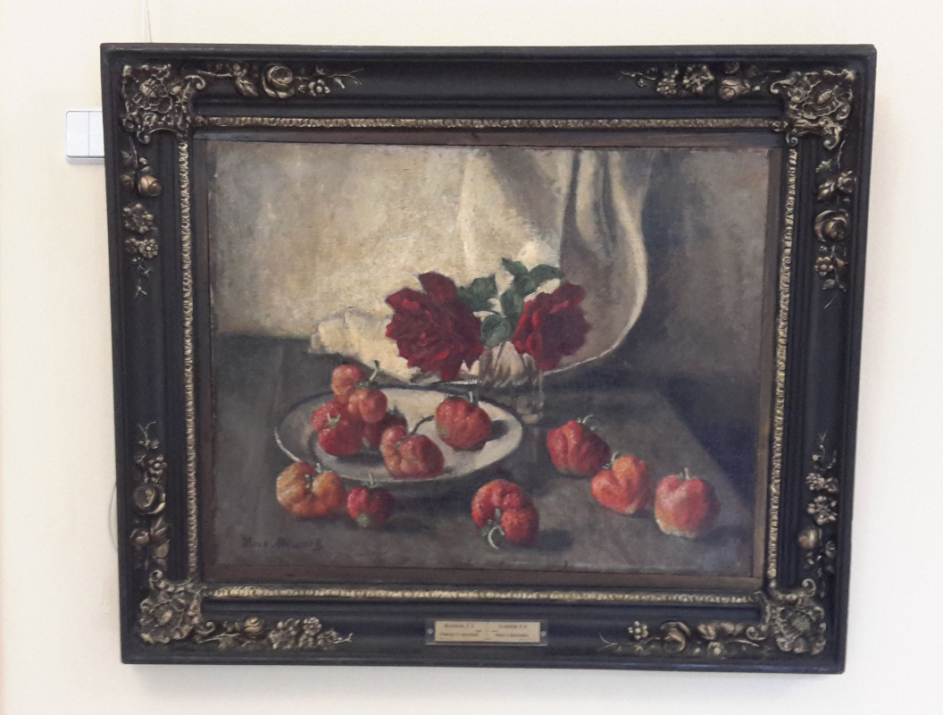 Two dark roses and a plate of strawberries